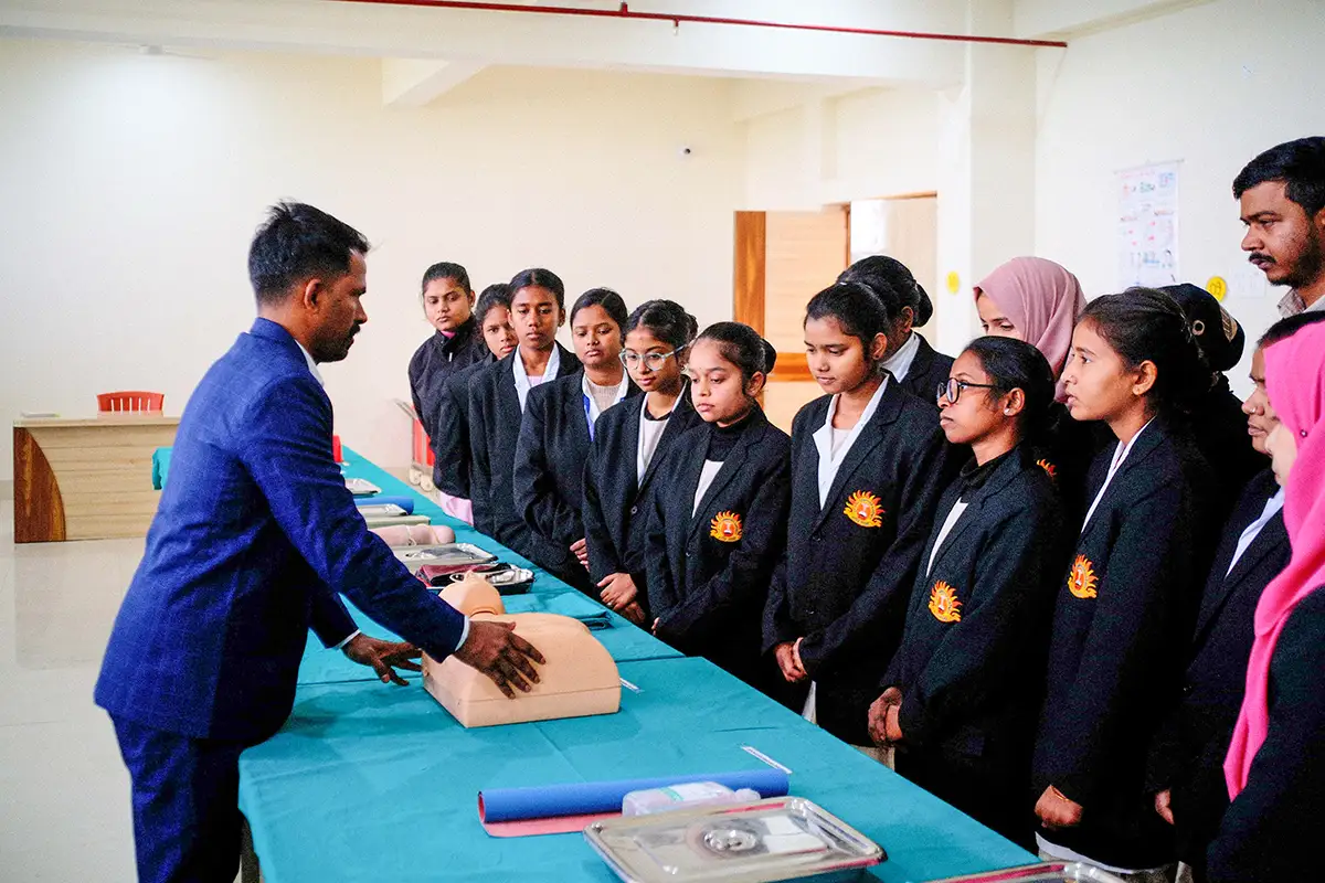 Nursing students attentively observing a clinical demonstration.