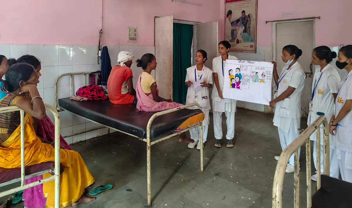 Students running a health awareness session in a hospital ward